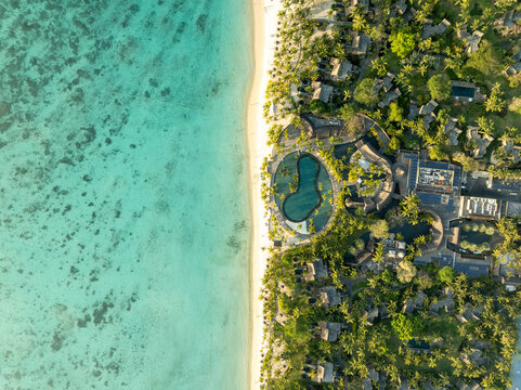Aerial view of beautiful tropical resort with sandy beach, clear blue water, and lush greenery, Trou aux Biches, Pamplemousses, Mauritius.