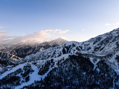 Aerial view of majestic snowy mountain range under a serene sky, Sundance, Utah, United States.
