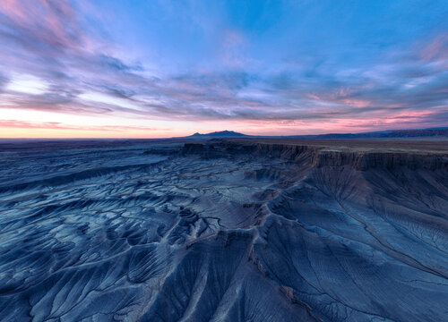 Aerial view of majestic moonscape overlook with beautiful canyon and plateau at sunset, Hanksville, Utah, United States.