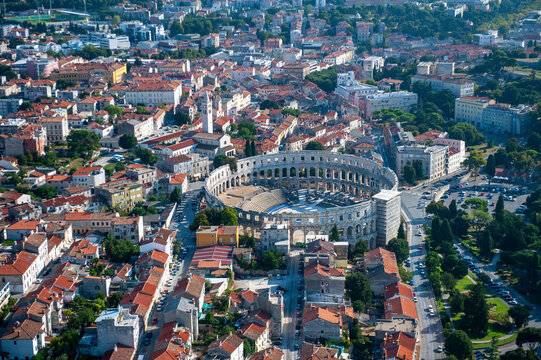 Fototapeta Aerial view of the historic amphitheatre surrounded by beautiful buildings and streets, Pula, Istria, Croatia.