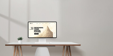 Desktop monitor displaying concept website with the header 'Designing your digital future', clean desk with open wall space for copy or branding