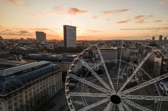 Aerial view of Poelaert Place Ferris Wheel at sunrise with beautiful skyline and historic architecture, Sablon, Brussels-Capital, Belgium.