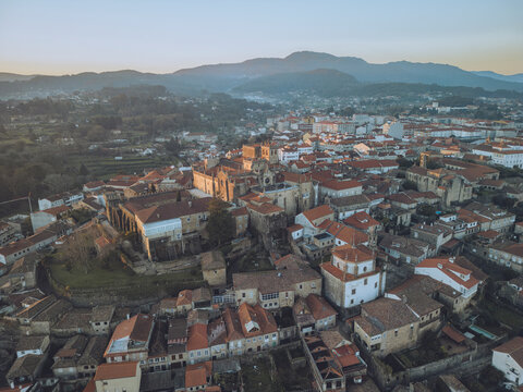 Aerial view of catedral de santa maria de tui and red rooftops in the historic old town surrounded by mountains, Tui, Pontevedra, Spain.