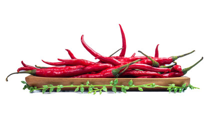 Fresh curly red chili peppers on wooden tray with artificial leaf decoration isolated on white...
