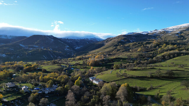 Aerial view of serene landscape with majestic mountains and a picturesque valley dotted with a rural village, Posof, Ardahan, Turkiye.