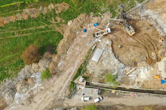 Aerial view of a construction site with excavators and machinery amidst dirt and grass, Kucukcekmece, Istanbul, Turkiye.