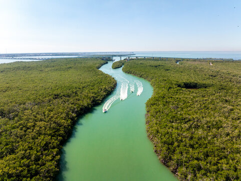 Aerial view of blackwater sound with serene waterway, boats, and lush mangroves, North Key Largo, Florida, United States.