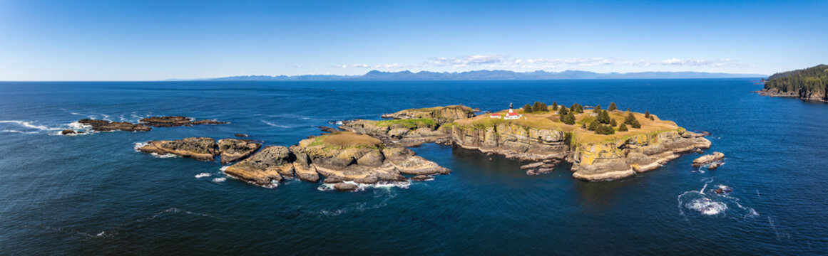 Aerial view of rugged cliffs and pristine coastline with a serene ocean, Cape Flattery, Washington, United States.