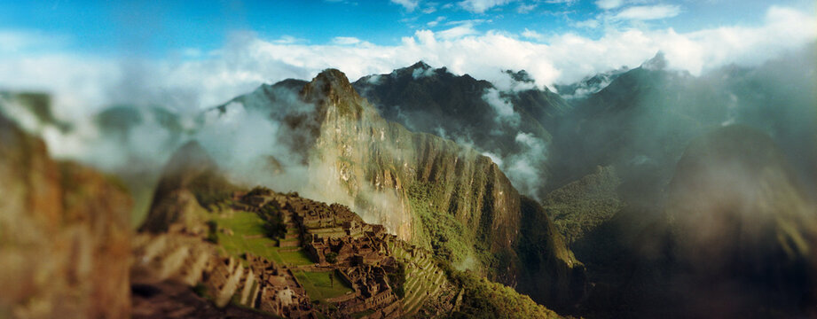 Panoramic view of ruins of an archaeological site, Inca Ruins, Machu Picchu, Cusco Region, Peru.