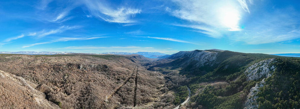 Aerial view of picturesque Baska valley surrounded by majestic mountains under a clear blue sky, Baska, Primorje-Gorski Kotar, Croatia.