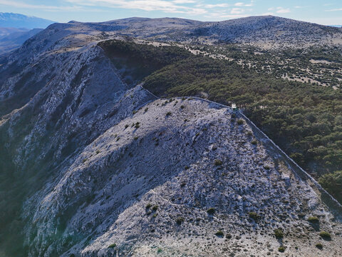 Aerial view of a breathtaking zip line station on a rugged mountain ridge with picturesque cliffs, Baska, Primorje-Gorski Kotar, Croatia.