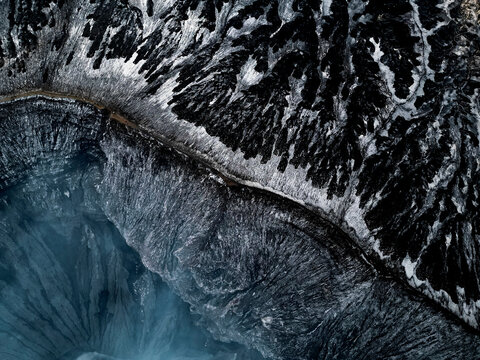 Aerial view of dramatic volcanic crater landscape with rugged terrain and breathtaking patterns, Sukapura, East Java, Indonesia.