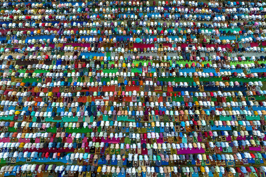Aerial view of colorful eid prayer gathering with diverse community, Mokamtala, Shibganj, Rajshahi, Bangladesh.