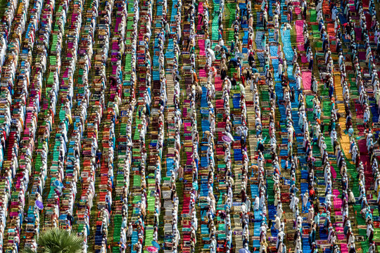 Aerial view of colorful congregation of people during Eid Prayer on prayer mats, Mokamtala, Shibganj, Rajshahi, Bangladesh.