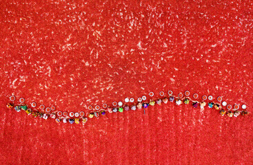 Aerial view of red chili pepper processing in a vibrant field with workers, Hat Sherpur, Sariakandi, Rajshahi, Bangladesh.