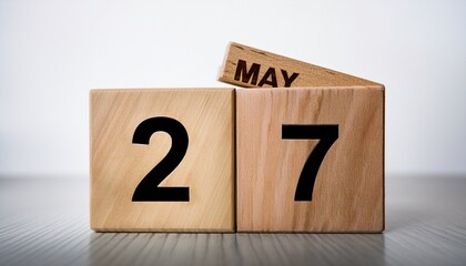 Minimalist photo of wooden blocks with date 27 May. Day and month, calendar on white background