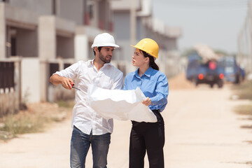 Architects and engineers work together to assess the residential home construction site's progress