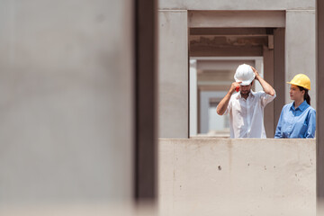 Architects and engineers work together to assess the residential home construction site's progress