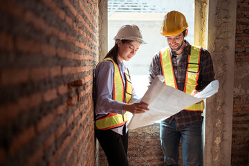 Architects and engineers work together to assess the residential home construction site's progress