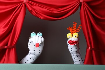 Creative puppet show on stage with red curtains