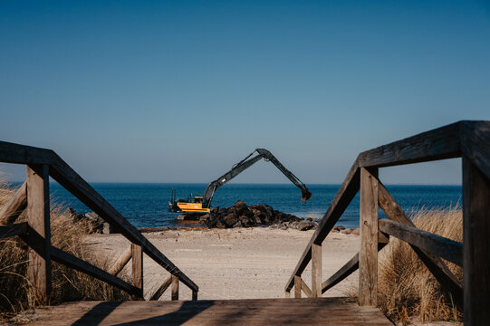 Beach Reconstruction with Heavy Machinery Moving Boulders in Heiligenhafen