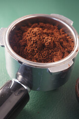 Freshly ground coffee in a portafilter ready for brewing espresso