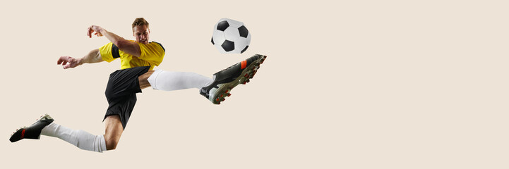 Focused man, soccer player in yellow jersey leaping to strike ball in high-speed motion captured in modern cut-out collage style. Concept of sport, competition, game. Banner. Copy space for ad