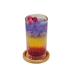  A vibrant layered mocktail with purple, yellow, and red hues, topped with flower garnish and ice