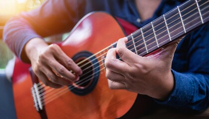Fototapeta premium Fingers playing a guitar strings