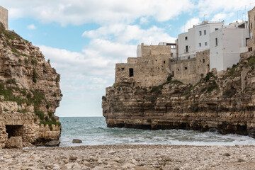 Lama Monachile Beach in Polignano a Mare with Clear Waters and Rocky Cliffs