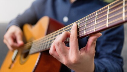 Fingers playing a guitar strings