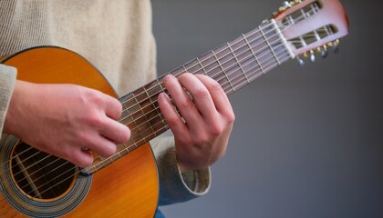 Fototapeta premium Fingers playing a guitar strings