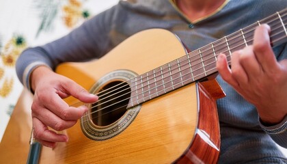 Fototapeta premium Fingers playing a guitar strings