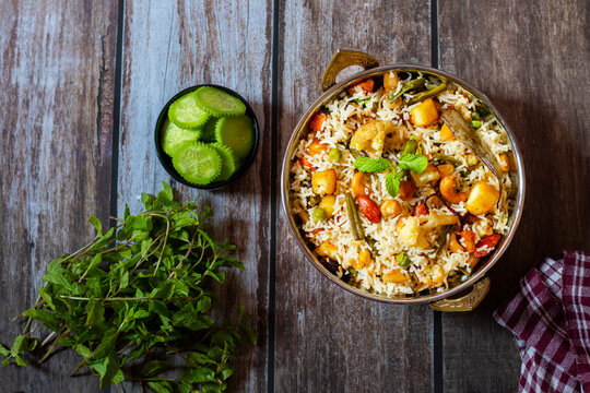 Navratan Pulao is a fragrant, colorful rice dish cooked with mixed vegetables, dry fruits, and aromatic spices, often served warm.