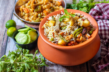 Navratan Pulao is a rich, aromatic Indian rice dish made with basmati rice, mixed vegetables, nuts, and dried fruits, offering a delightful sweet-savory flavor.