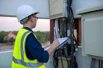 Telecommunication engineers work at cell towers for 5G cell phone signals,Network tower maintenance...