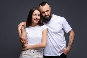 Obraz premium Portrait of happy daughter and father on dark grey background