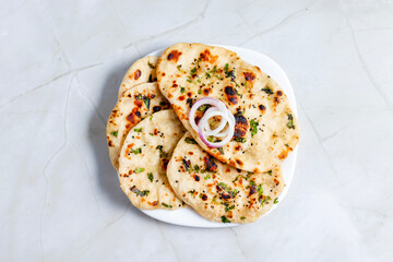 Butter naan is a soft, leavened Indian flatbread brushed with melted butter, perfect for pairing...