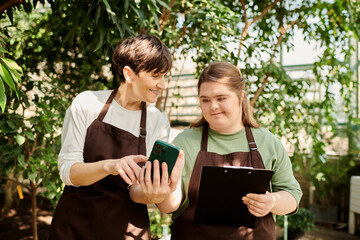 Collaboration in a greenhouse between a mature woman and her young colleague with Down syndrome