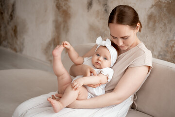 mom and baby, mother gently hugs her baby, kissing him at home, motherhood and caring