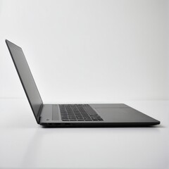 Sleek and Minimalist: A Side View of a Modern Black Laptop Displayed Against a Plain, Clean White Background.