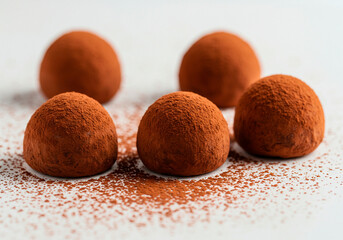 Five chocolate truffles dusted with cocoa powder offer pure indulgence. Ideal for gourmet menus or luxury gift concepts, this rich visual invites indulgence, celebrating delicious handmade sweets.