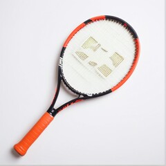 Close-up of a tennis racket with bright orange grip, resting on a neutral surface, capturing detail and texture.