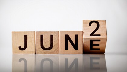 Obraz premium Minimalist photo of wooden blocks with date 2 June. Day and month, calendar on white background