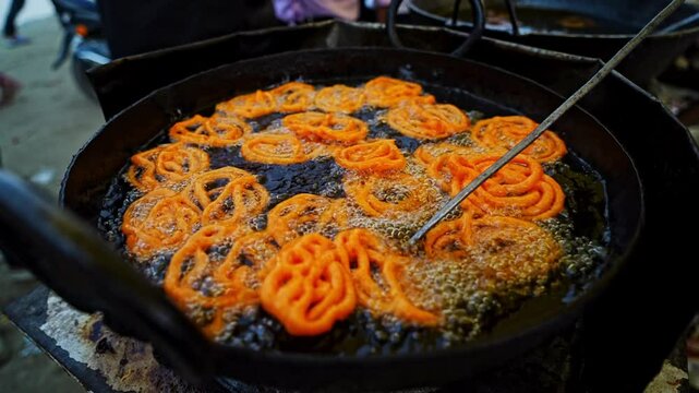 Street vendor frying jalebi Indian sweet food