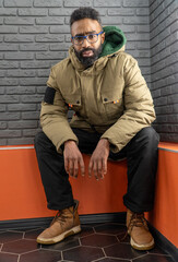 Portrait of a thoughtful, serious young man of African-American nationality with a beard close-up....