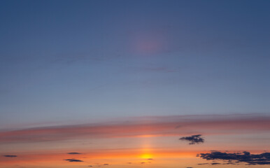 Obraz premium Orange sunset and golden sun in bright clouds