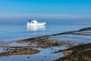 A ship on the river thames viewed from the Cliffe RSPB nature reserve near Gravesend in Kent, England