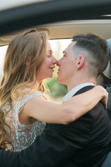 Couple about to kiss in a romantic embrace inside a car. Love, intimacy, connection and emotional closeness captured in a candid moment in wedding day