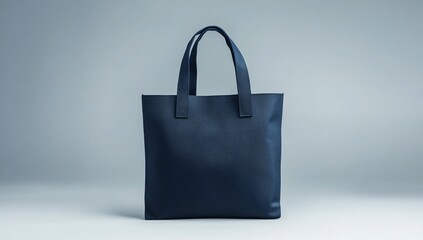 Navy blue tote bag isolated on light gray background.